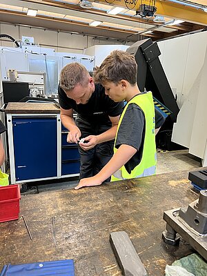 Alupress Tooling employee with young inventor